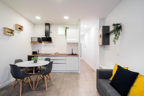a kitchen and a living room with a table and chairs at Nice apartment in the center of Madrid-S-EL-VERDE in Madrid