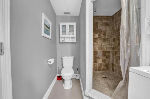 a white bathroom with a toilet and a shower at Adorable 1 BDR with Full Kitchen Deck Washer Dryer in Panama City