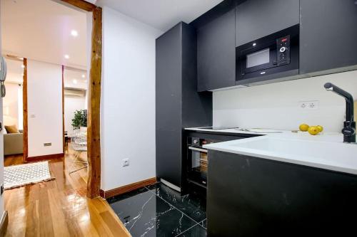 a kitchen with a sink and a microwave at Cozy flat in the center of Madrid-COMEND-3-DE in Madrid