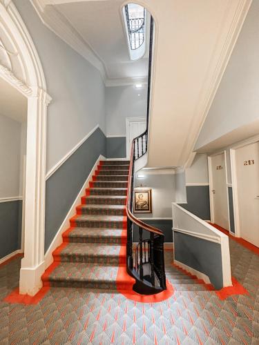 a staircase in a building with a skylight at GRANDE HOTEL PARIS by STAY HOTELS in Porto