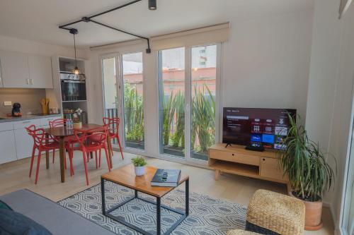 a living room with a table and a tv and a kitchen at MyPlace at Santo Domingo in Mexico City
