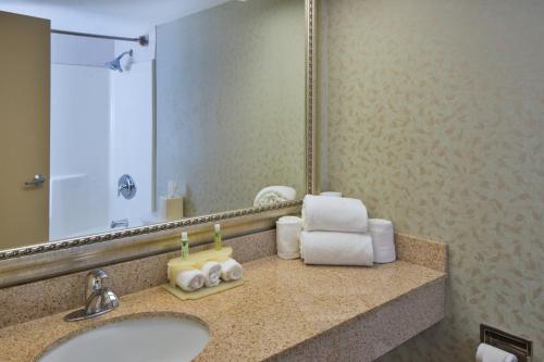 a bathroom with a sink and a mirror and towels at Holiday Inn Express Exton - Great Valley by IHG in Exton