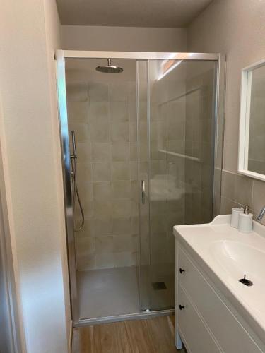 a shower with a glass door in a bathroom at Vicolo San Giuseppe 8A e 8B in Alba
