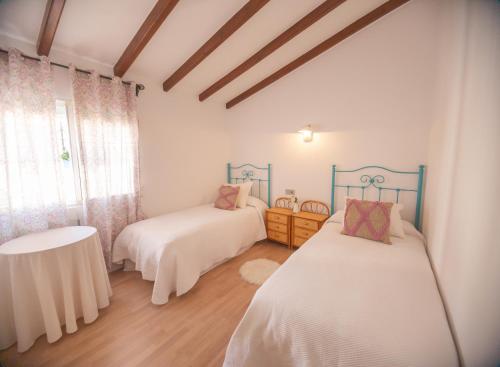 Postel nebo postele na pokoji v ubytování Casa con jardín junto a la playa