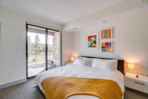 a bedroom with a large bed and a balcony at Modern Winter Park Condo with Community Hot Tub! in Winter Park