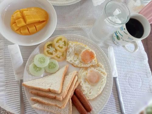 a plate of breakfast food with eggs and toast at Skott's Comfy Lodge in Bantayan Island