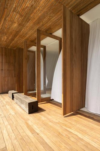 a room with wooden floors and a wooden ceiling at KA BRU 1100 Boutique Hotel in Taipu