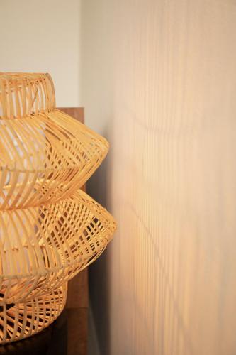 a wicker basket sitting next to a wall at KA BRU 1100 Boutique Hotel in Taipu