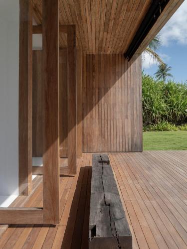 a wooden porch of a house with a wooden floor at KA BRU 1100 Boutique Hotel in Taipu