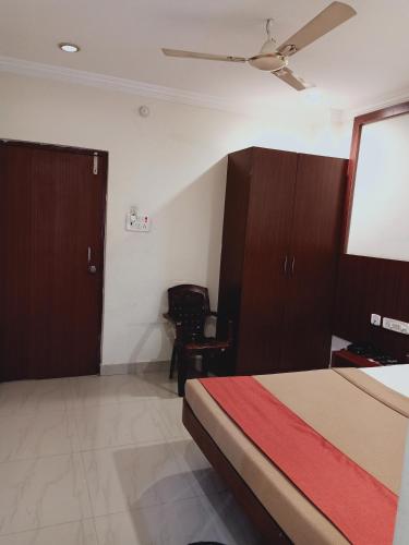 a bedroom with a bed and a flat screen tv at Hotel Neem Tree Hyderabad Airport in Shamshabad