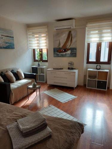 a living room with a couch and a table at Old city apartment in Rovinj