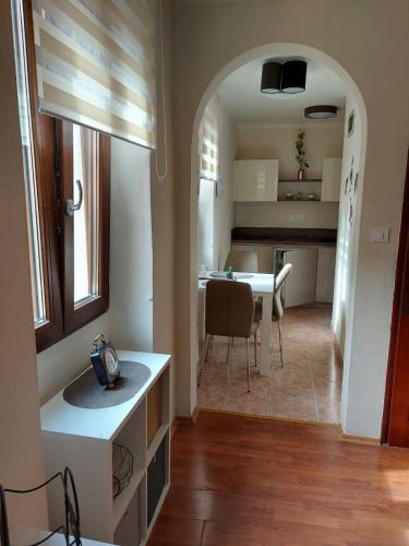 a kitchen and living room with a table and a dining room at Old city apartment in Rovinj