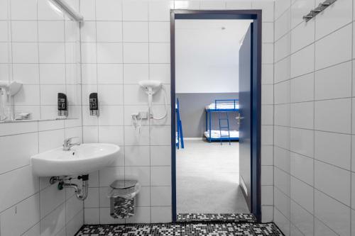 a bathroom with a sink and a mirror at Pegasus Hostel Berlin in Berlin