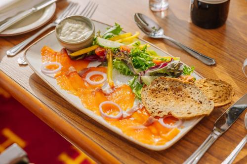 a plate of food with a salad and a sandwich at Muthu Alexandra Hotel in Oban