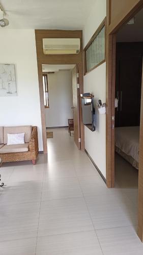 a hallway with a room with a bed and a television at La View 麗晨 Homestay in Manzhou