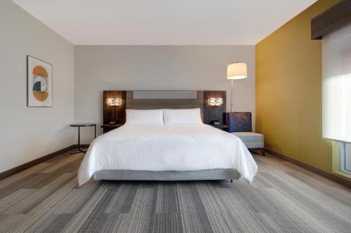 a bedroom with a large bed and a desk at Holiday Inn Express & Suites - Glendale Downtown in Glendale