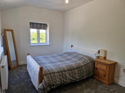a bedroom with a bed and a window at Brand New Barn Retreat in Bedford