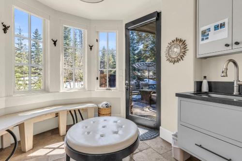 a kitchen with a bench and a sink and windows at West Red Pine Oasis in Park City
