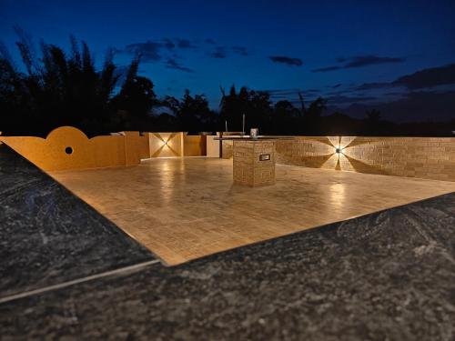 a wooden deck with lights on top of a building at Treva Pent House in Karaikal
