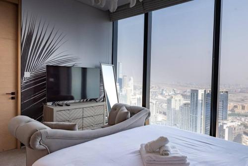 a hotel room with a bed and a television at Luxury1BR at The Address Residences in JBR in Dubai