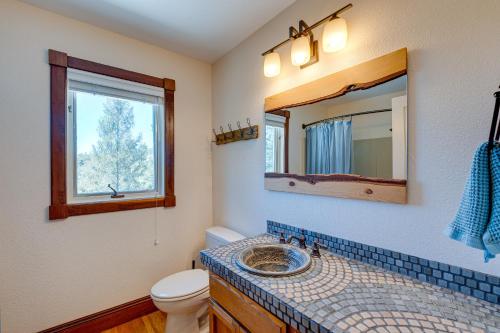 a bathroom with a sink and a toilet and a mirror at Meadow Vista Mountain Escape with River Views! 