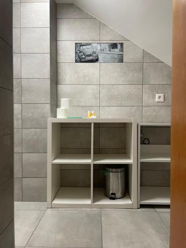 a bathroom with a white cabinet in a wall at HL Łebski Apartamenty in Łeba