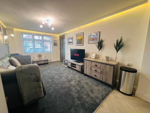 a living room with a couch and a television at The Annex in Southend-on-Sea