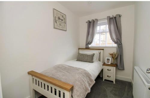 een kleine slaapkamer met een bed en een raam bij Home from home in Bexhill