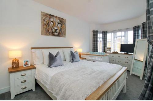 a bedroom with a large bed and a television at Home from home in Bexhill