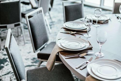 a table with plates and wine glasses on it at Hilton Garden Inn Denver Union Station in Denver
