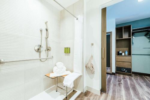 a bathroom with a shower and a table at Hilton Garden Inn Denver Union Station in Denver