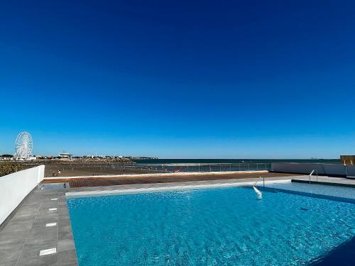 - une piscine avec vue sur la plage dans l'établissement L'Escale SUNRISE panorama sur l'estuaire, à Royan