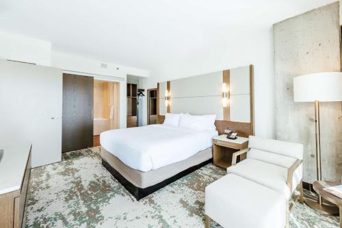 a hotel room with a bed and a chair at Hilton Garden Inn Denver Union Station in Denver