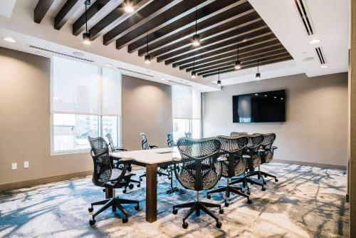 a conference room with a table and chairs at Hilton Garden Inn Denver Union Station in Denver