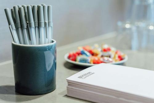 a cup of straws next to a plate of candy at Hilton Garden Inn Denver Union Station in Denver