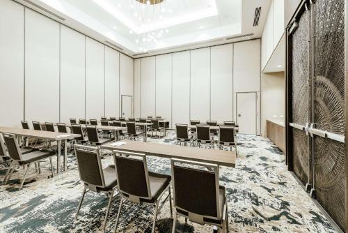 a room with rows of tables and chairs at Hilton Garden Inn Denver Union Station in Denver