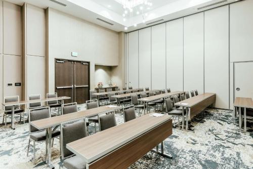 a classroom with tables and chairs and a chalkboard at Hilton Garden Inn Denver Union Station in Denver