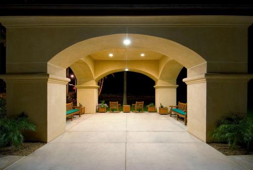 an archway in a building with chairs and tables at Hilton Garden Inn Carlsbad Beach in Carlsbad