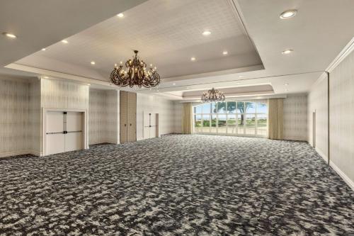 an empty ballroom with a large room with a chandelier at Hilton Garden Inn Carlsbad Beach in Carlsbad