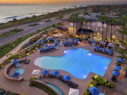 an overhead view of the pool at the resort with the ocean in the background at Cape Rey Carlsbad Beach, A Hilton Resort & Spa in Carlsbad