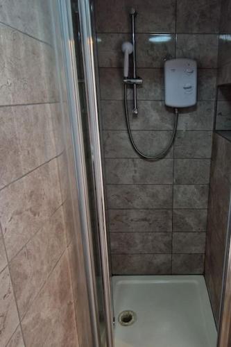 a bathroom with a shower with a shower at Quiet and cozy studio in Hendon