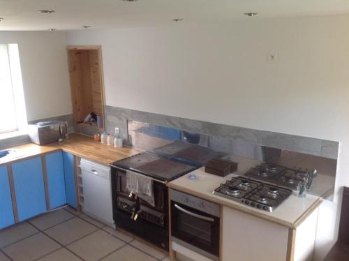a kitchen with a stove and a counter top at Freval in Clairefougère
