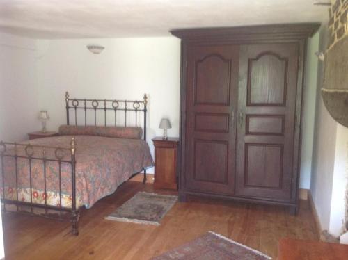 a bedroom with a bed and a wooden door at Freval in Clairefougère
