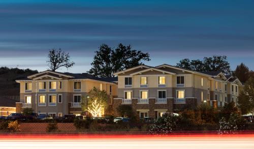 a row of apartment buildings at night with a street at Homewood Suites by Hilton Agoura Hills in Agoura Hills