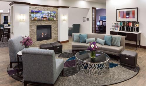 a lobby with a couch and chairs and a fireplace at Homewood Suites by Hilton Agoura Hills in Agoura Hills