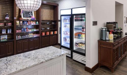 a grocery store with a refrigerator and a counter at Homewood Suites by Hilton Agoura Hills in Agoura Hills