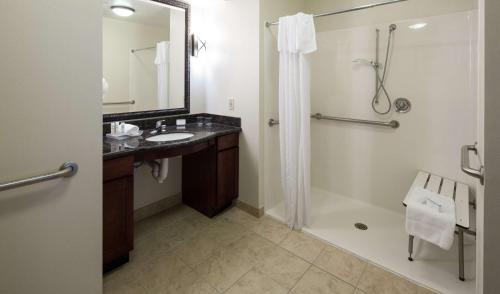 a bathroom with a shower and a sink and a shower at Homewood Suites by Hilton Agoura Hills in Agoura Hills