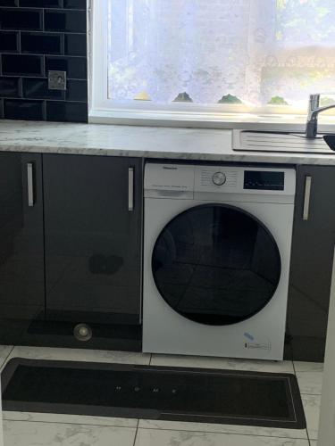 a microwave oven sitting under a counter in a kitchen at T Lodge in Abbey Wood