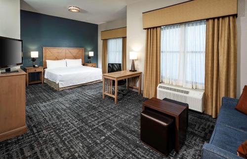 a hotel room with a bed and a television at Homewood Suites by Hilton Austin/Round Rock in Round Rock