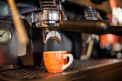 a coffee maker making a coffee cup on a counter at Best Western Brome Grange Hotel in Brome